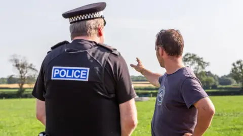 John Cottle/NFU A farmer with a police officer