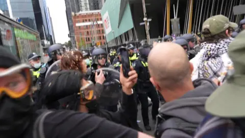 Police push protesters back on the street