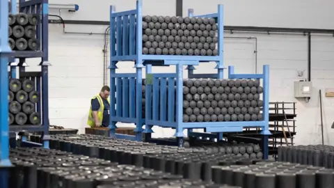 Getty image inspects an artillery shell at a BAE Systems Factory in Washington near Newcastle on an employee tain.