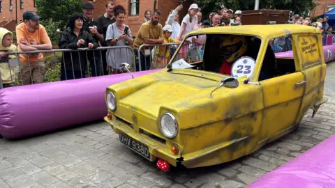 A yellow Reliant Robin-shaped kart, emulating the look of the vehicle featured in the television series Only Fools and Horses.
