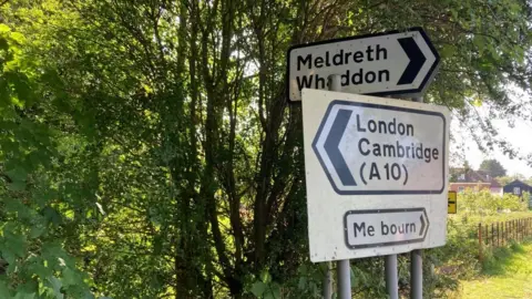 Brian Farmer/BBC Road sign pointing to Meldreth, Cambridge and "Me bourn"