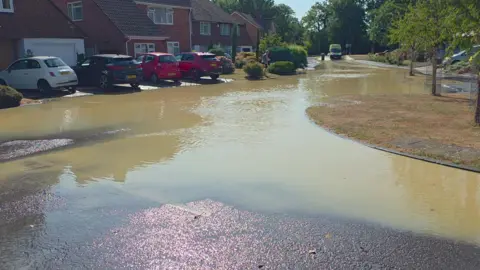 A flooded residential road. 