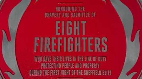 FIRE BRIGADES UNION Close up of one of the red plaques to be placed in Sheffield city centre. Lettering states the loss of life during the blitz by firefighters