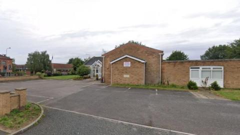 Google street image of Brigg Methodist Church, fairly quaint building with car park and houses surrounding it