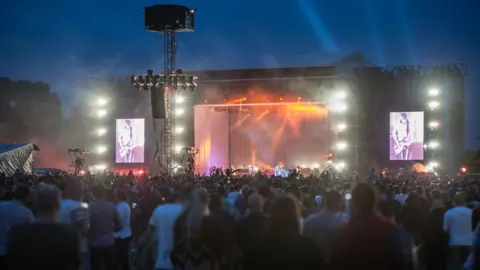 Getty Images A brightly lit stage hosting a rock concert