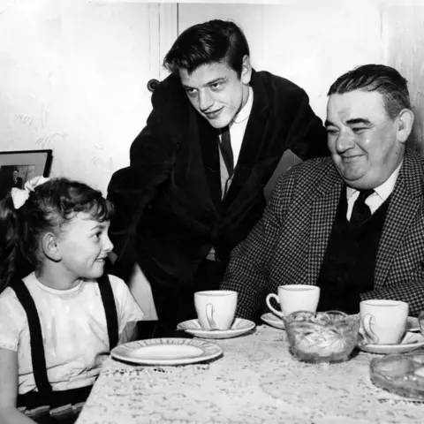 Mirrorpix A black and white image of Susan, along with Mel Parry and Victor Jones - they are sat around a table having tea.