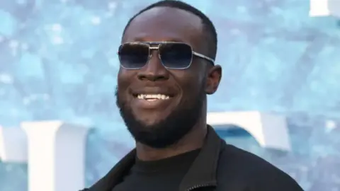 Getty Images Stormzy wearing sunglasses and a black top