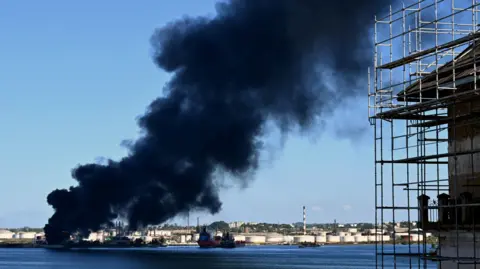 Black smoke billows from a fire at the Nico Lopes oil refinery in Havana