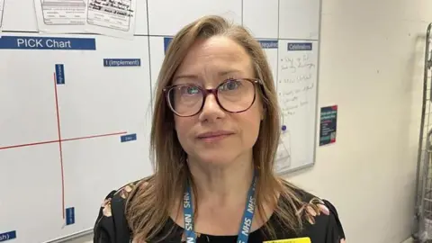 Tracy Stocker, Director of Operations at Medway Maritime Hospital, standing in front of a whiteboard in the virtual ward office