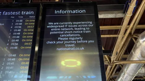 Steve Hubbard/BBC A screen at Bedford station warns about widespread IT issues