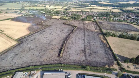 Wiltshire Search and Rescue An aerial image showing black scorched fields with farm buildings nearby.