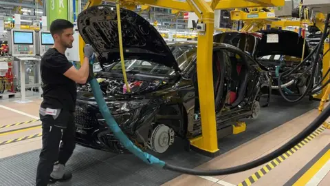 Reuters An employee of German car manufacturer Mercedes-Benz works on a Mercedes CLA class model at the production line at the factory in Rastatt, Germany.
