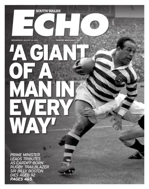 South Wales Echo Main headline: 'A giant of a man in every way'. Next to a black and white image of Sir Billy Boston playing in a game of rugby league. Someone is trying to tackle him with their arm wrapped around him.