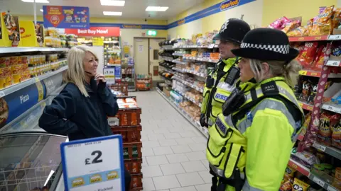 Nicola Lewis with local police officers