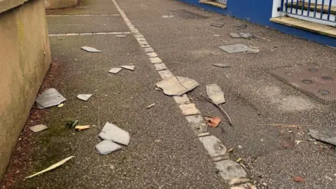 The concrete pavement with roof tiles on the ground.