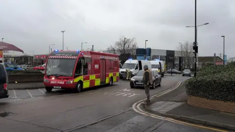 Fire service command vehicle and other emergency service vehicles on the side of a road