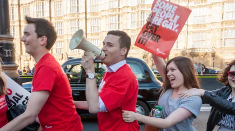 Getty Images Wes Streeting pictured doing a conga with activists from Stonewall outside Parliament in 2013