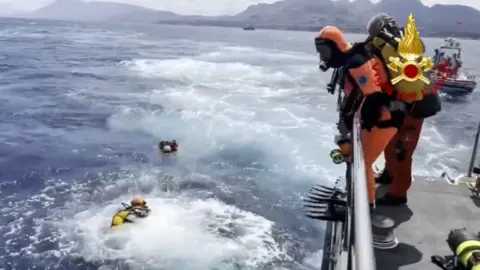 EPA A handout video grab made available by Vigili del Fuoco shows cave divers from the Italian fire brigade as they prepare to resume inspections of the Bayesian yacht's wreck, off the coast of Sicily