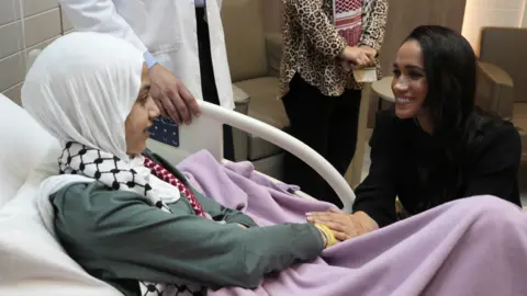 The Duchess of Sussex meets Maria, a 14-year-old burn victim from Gaza, during a visit to the Specialty Hospital in Amman