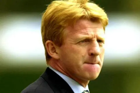 Press Association/ Rui Vieira Gordon Strachan, wearing a dark jacket over a blue shirt and tartan tie.