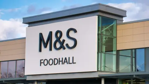 A large M&S Foodhall sign above the entrance to one of its branches