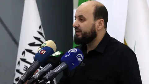 Mohamed al-Bashir, who heads HTS's so-called "Salvation Government", holds a press conference in the rebel-held northwestern Syrian city of Idlib on 28 November 2024