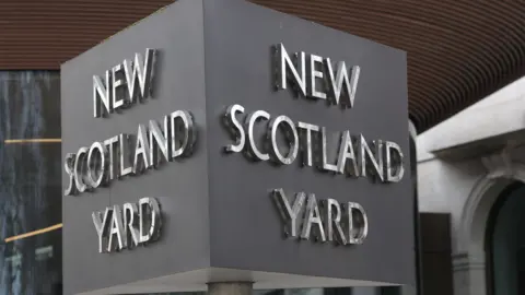A general view of a New Scotland Yard sign outside the Metropolitan Police headquarters.