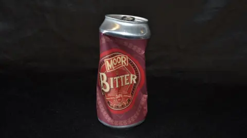 A picture of a can of bitter that has been drunk and the can crumpled slightly. 