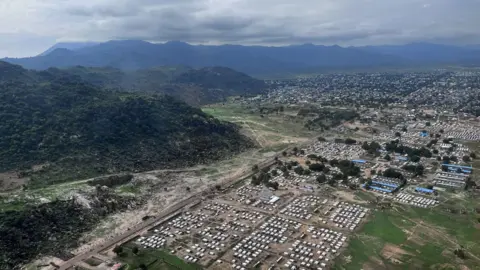 Aid cuts will push Nigerians into arms of Boko Haram militants, UN warns Anne Soy / BBC A drone shot of Gwoza showing the houses from displacement camps and the surrounding hills - July 2025.