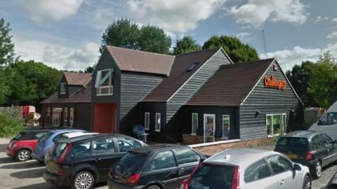 A Google maps image of the Challengers play centre, a black weather-boarded building, and carpark in Stoke Park 