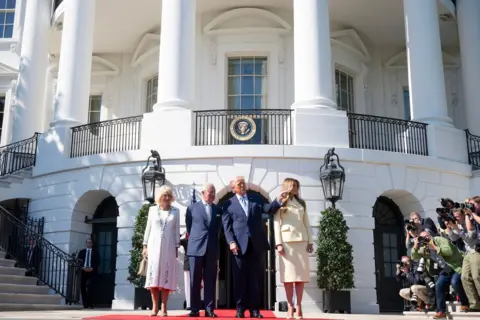 Brendan Smialowski / AFP via Getty Images Camilla and Charles stand next to Donald and Melania Trump as Donald Trump points to the right of frame in front of the White House as reporters photograph them.
