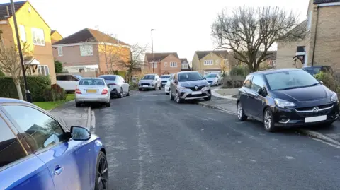 York Liberal Democrats About 10 cars can be seen parked on the footpath of a residential street. 
