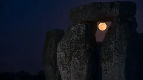 Andre Pattenden/English Heritage Night-time with some of Stonehenge and the Moon visible