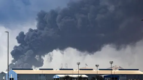 EPA Thick black smoke billows into the air above the Jebel Ali port after getting struck by debris from an Iranian intercepted missile, in Dubai.
