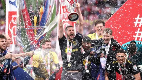 Getty Images Jack Stephens of Southampton lifts the Sky Bet Championship Play-Off Final Trophy after his team's victory, after Southampton secure promotion to the Premier League after defeating Leeds United.