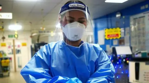 A medical worker in full protective equipment.