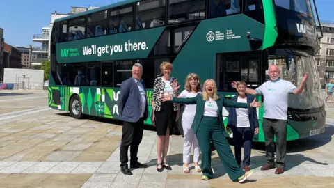 Six people standing in front of a bus; the leaders of Bradford, Calderdale, Kirklees, Leeds and Wakefield Councils, (Susan Hinchcliffe, Jane Scullion, Carole Pattison, James Lewis and Denise Jeffery) plus West Yorkshire Mayor Tracy Brabin, unveiling West Yorkshire's new Weaver transport network in Leeds.