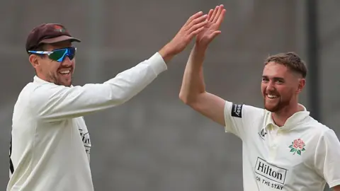 Tom Bailey and George Balderson celebrate a wicket