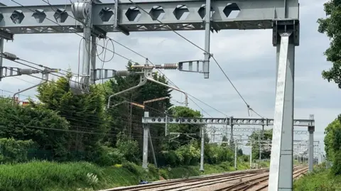 Cables run over the top of a railway line
