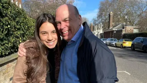 Family handout A picture of Hannah and her father Mike Lynch standing on a street, with his arm around her shoulders
