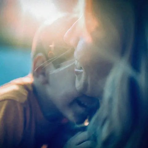 Getty Images Mother hugging her young son