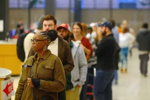 GAMAL DIAB/EPA People wait in line at the polling station in the Martin Luther King Jr Memorial Library in Washington DC, US, 5 November 2024