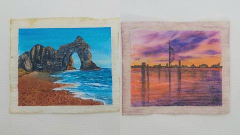 Two flat teabags, one has Durdle Door painted on, the other has the Spinnaker Tower painted