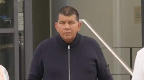 BBC/Shaun Whitmore Richard Jones, wearing a dark zip up top, is pictured leaving Ipswich Crown Court