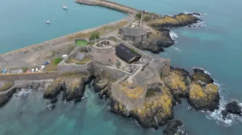 A drone shot of St Aubin's fort, surrounded by the sea at high tide.