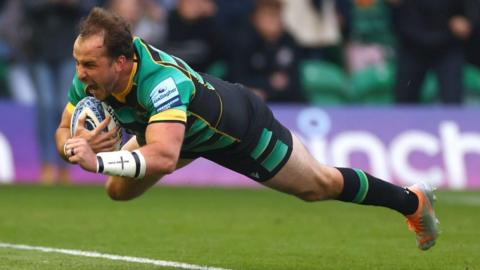Burger Odendaal dives over the line to score the game's first try for Northampton Saints against Saracens
