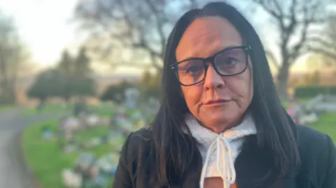Sarah McCrackle at Wilford Hill Cemetery in Nottinghamshire where here son Junior is buried