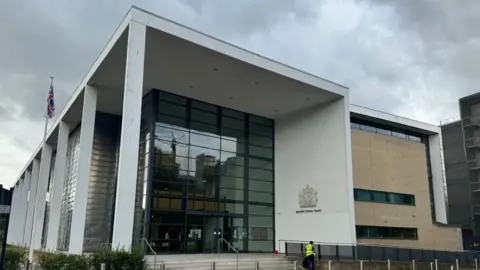 George King/BBC An image showing the front of Ipswich Crown Court and the glass entrance which leads into the foyer