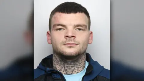 Derbyshire Police A photo of Brandon Brooks in police custody with a skull tattoo on his neck