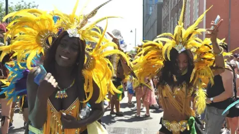 BBC Dancers in yellow outfits at St Pauls Carnival in Bristol